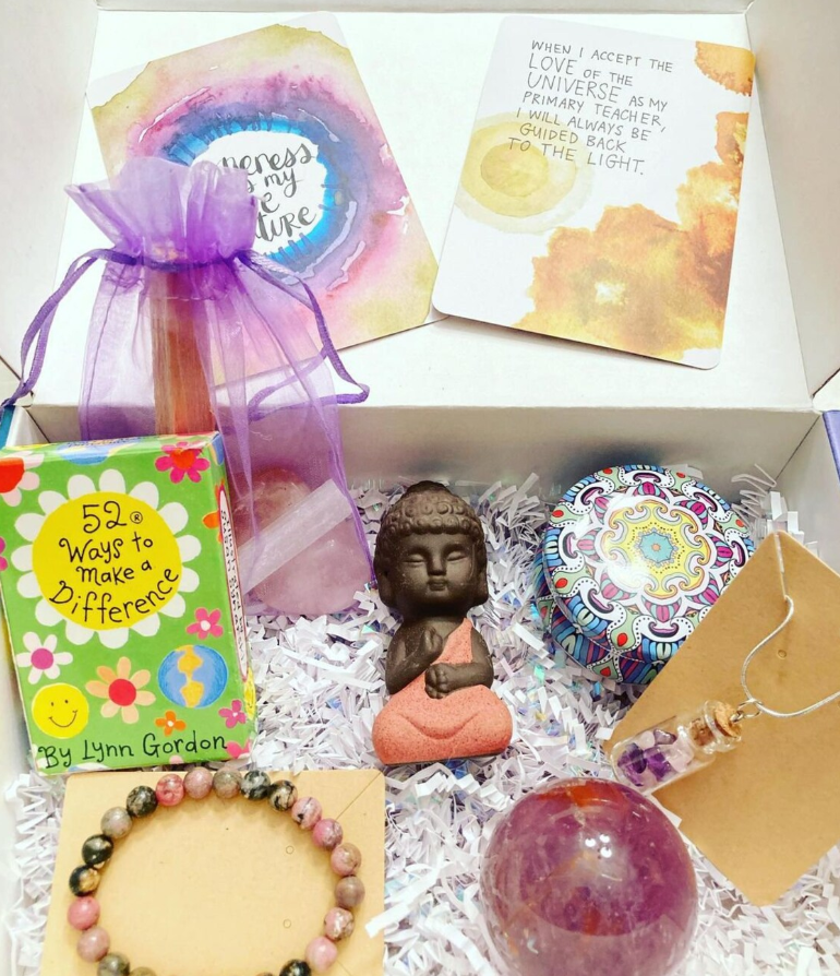 Monthly box with affirmation cards, buddha figure, bracelet, crystal ball and keepsakes