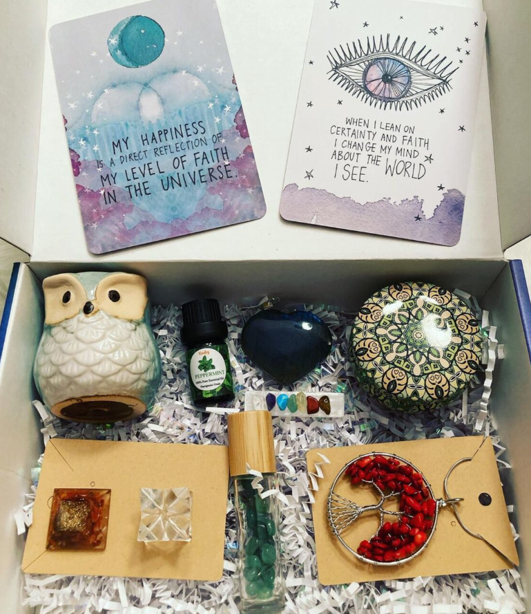 Monthly box with affirmation cards, owl diffuser, peppermint oil, tree of life pendant and crystals